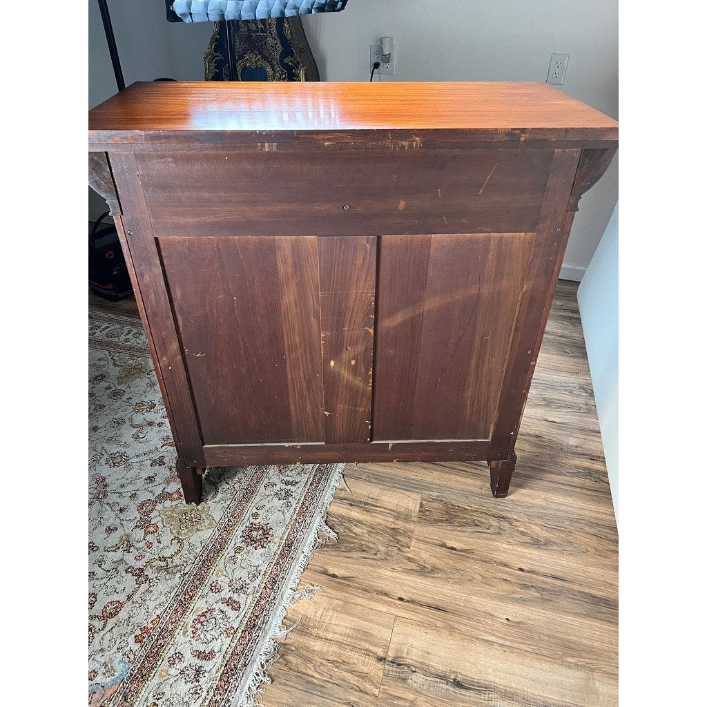 An Antique English Jacobean Revival Mahogany Buffet (c. 1915–1925) with a reddish-brown finish, visible scratches, and carved ball and claw feet stands on a wood floor near a patterned rug in a white-walled room. Brand: Unknown.