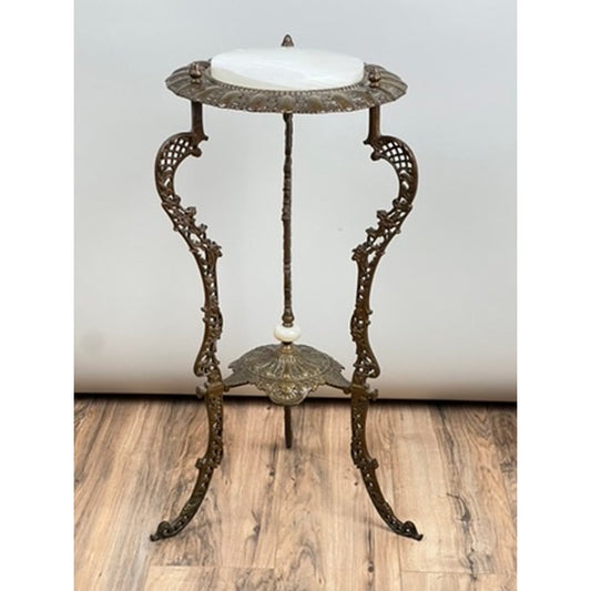 Antique Victorian Bronze and Onyx Stand by Pearl City Antiques, dating to the late 19th century, featuring ornate bronze metalwork, elegant legs, a round onyx top, and intricate decorative detailing, displayed on a wooden floor against a plain background.
