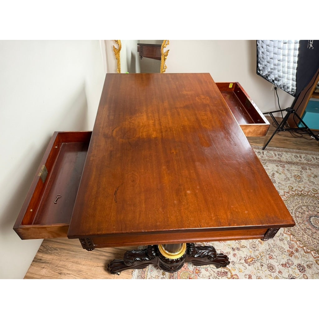 A New York Classical Revival Carved Mahogany Double-Pedestal Library Table, labeled Ernest F. Hagen, circa 1890–1925, shown as a rectangular mahogany table with a double-pedestal base and two drawers pulled open on opposite sides.