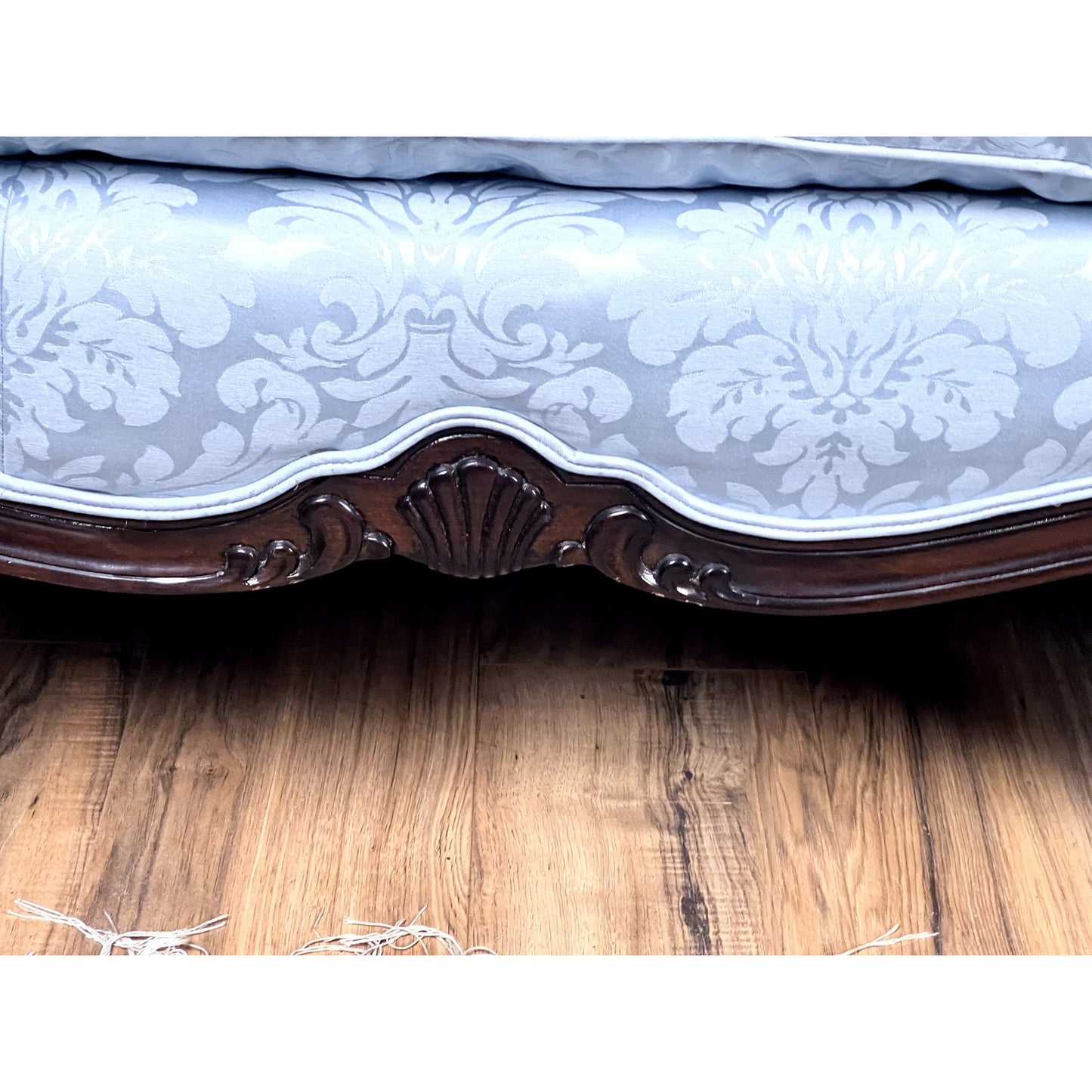 The image features a Vintage Louis XV Rococo Style Sofa, newly upholstered in pale blue damask fabric, displaying a carved shell motif on its ornate lower frame, and placed on a medium-toned wood floor. Brand is unknown.