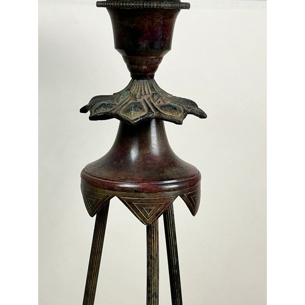 A close-up of a Vintage Verdigris Bronze Neoclassical Style Glass End Table with intricate bronze designs and slender legs, featuring a subtle verdigris patina, set against a plain, light background.