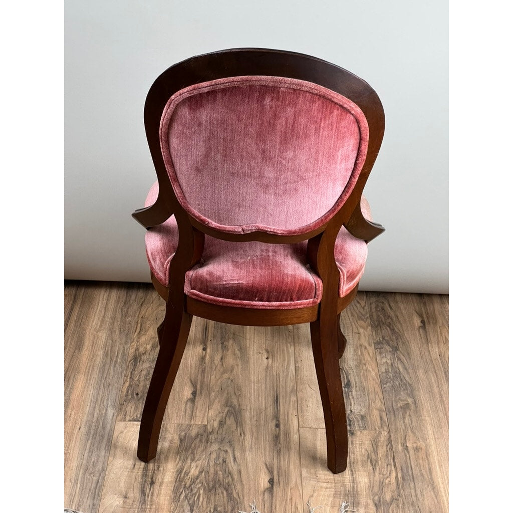 An Antique Victorian Walnut Tufted Balloon Back Side Chair (late 19th century) with curved legs and pink velvet upholstery stands on a wooden floor against a light gray wall. Brand: Unknown.