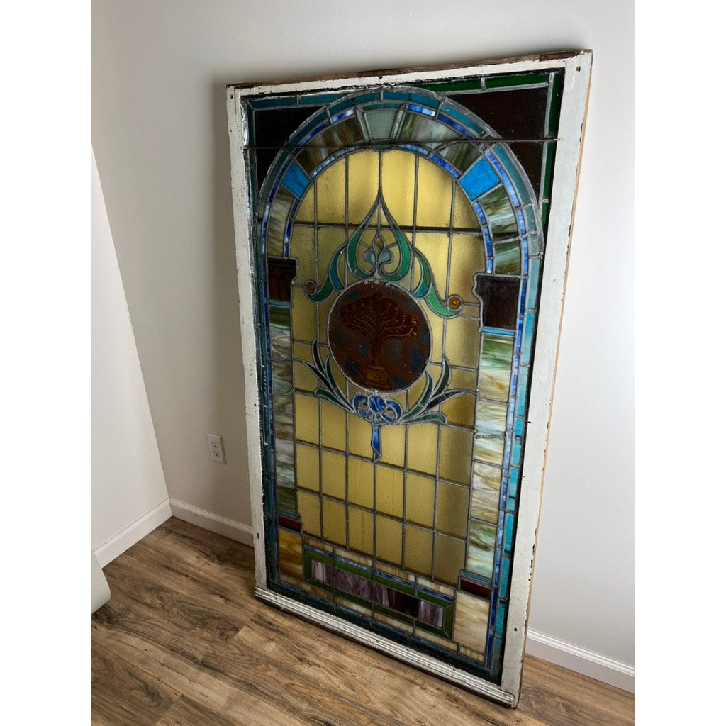 Early 20th century stained glass window in original wood frame