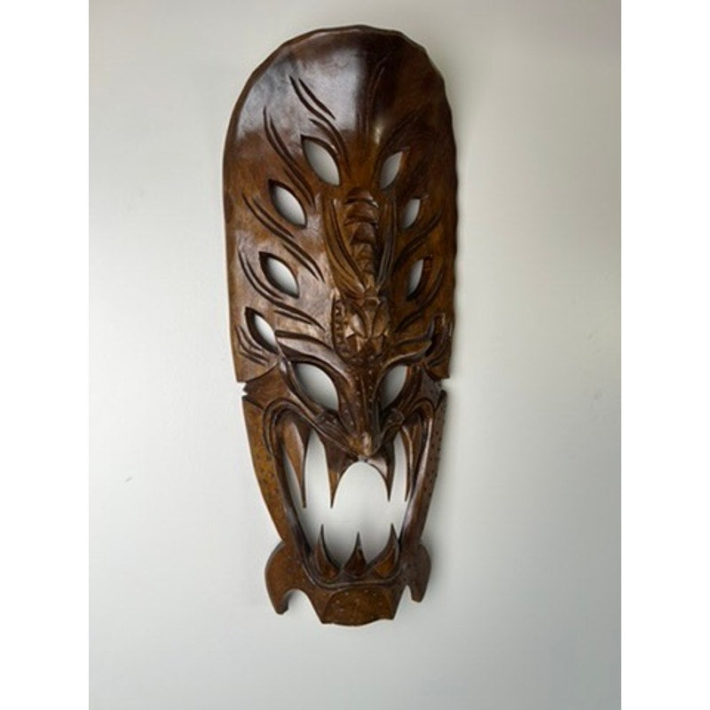 Large wood carved dragon mask with fierce fangs and openwork eyes