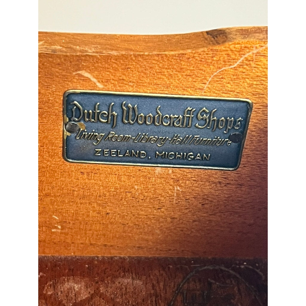 A metal label reading "Dutch Woodcraft Shops, Living Room Library Hall Furniture, Zeeland, Michigan" is affixed to this Vintage Dutch Woodcraft Shops Federal Style Flame Mahogany Chest on Stand (c. 1945–1955), highlighting the expert workmanship and timeless elegance of this remarkable piece.