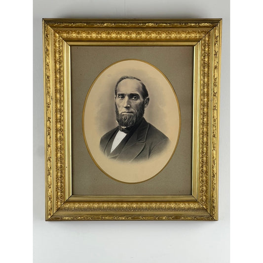 Presented by Pearl City Antiques, this Antique Civil War Era Portrait of a Gentleman is displayed in an ornate gilt wood frame with intricate floral details. The sepia-toned image, featuring a bearded man in a suit against a neutral background, stands as a striking example of 19th-century American photography.
