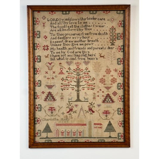 Presenting the Exceptional English Regency Schoolgirl Needlework Sampler by Charlotte Rees, Age 11, Dated 1816 from Pearl City Antiques. This framed sampler features a finely embroidered tree, geometric shapes, and a religious poem stitched in colored thread on fabric. At the bottom, it displays the name “Charlotte” alongside charming house and animal motifs—an exquisite example of antique embroidery from the English Regency period.
