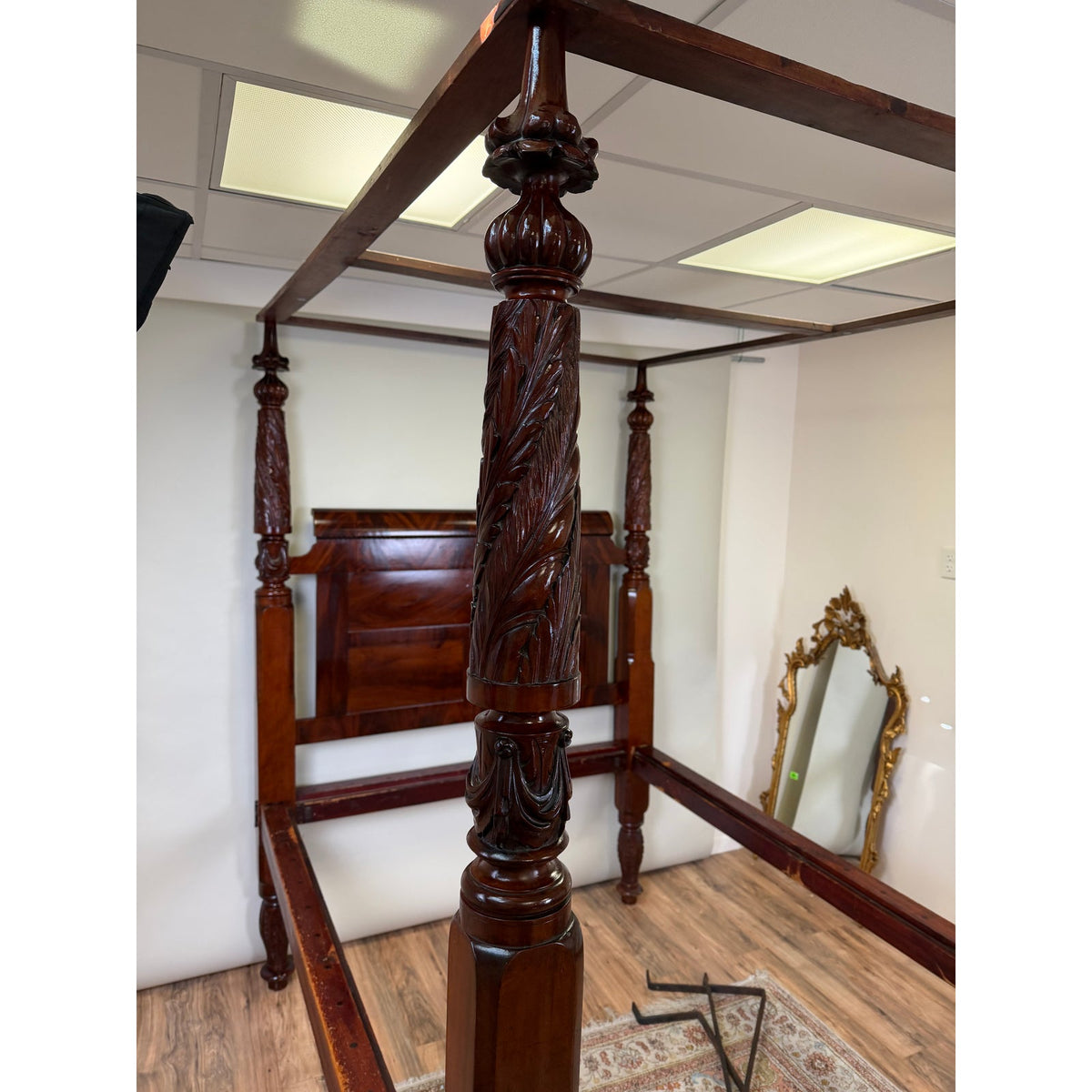 American Classical Carved Mahogany Four-Poster Tester Bed, possibly New York, circa 1825–1840, featuring tall, intricately carved columns with leaf motifs.