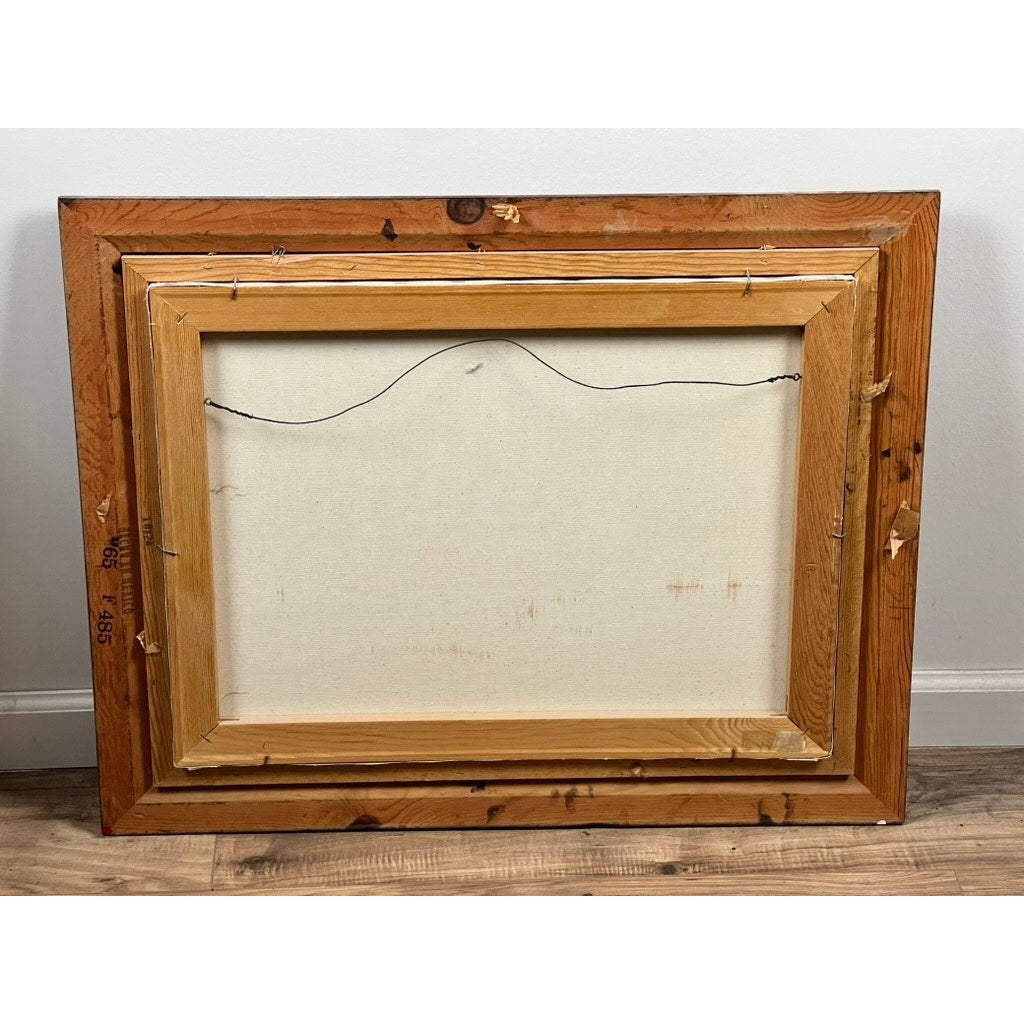 The back of “Tall Ship Under Sail” Oil on Canvas by John Richard Perry ME 1984 is shown, displaying a wooden frame, hanging wire, and stretcher bars. The artwork’s front isn’t visible. The frame leans against a white wall on a wooden floor.