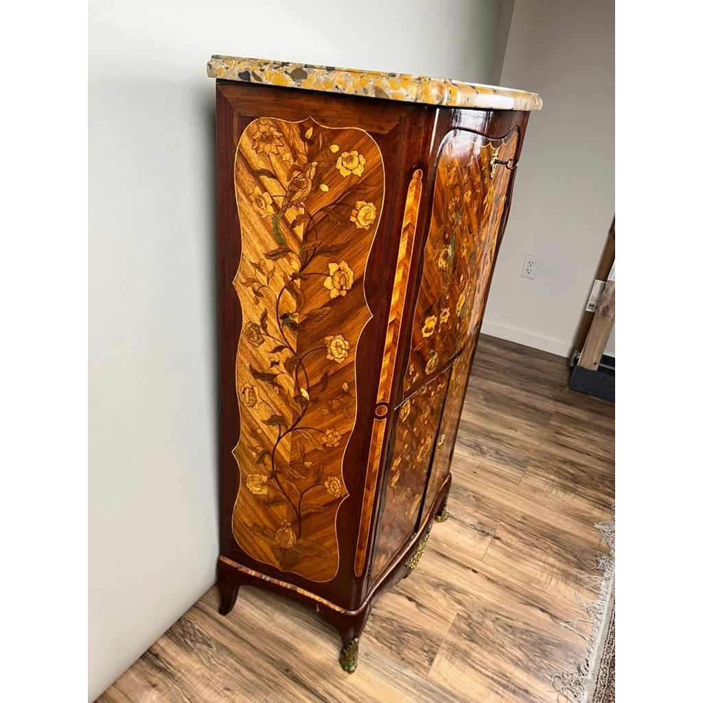 A Secrétaire à abattant d'époque French Louis XV Style Inlaid Diminutive Secretary c. 19th Century, with floral marquetry and a marble top, stands against a light wall on a wooden floor, featuring intricate details and elegant curved legs.