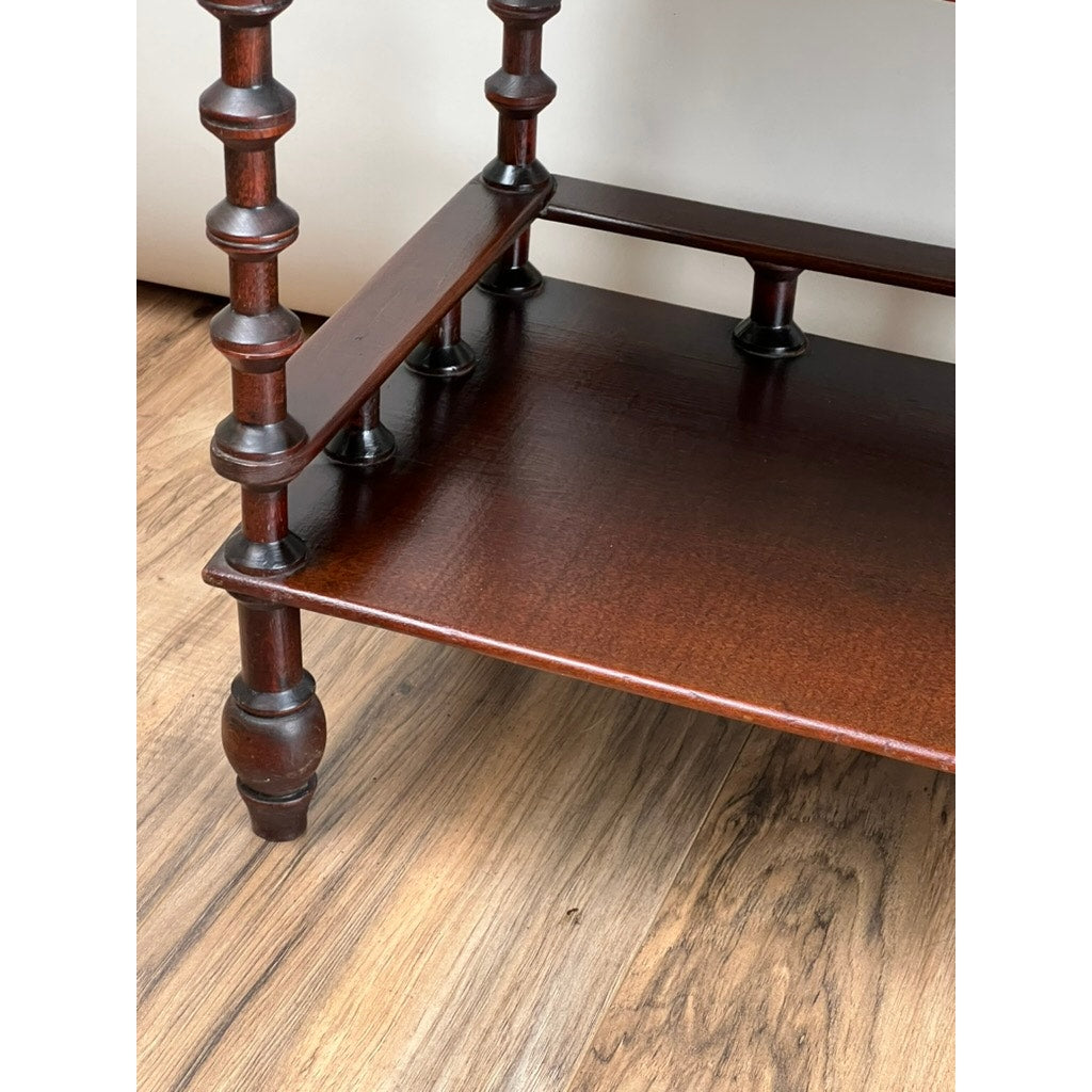 Close-up of a Vintage Bobbin-turned, Three Shelf Wooden étagère or Whatnot with spindle gallery and turned legs, featuring a lower shelf and glossy finish. It sits on a light brown wood floor with a classic vintage design. Brand: Unknown.