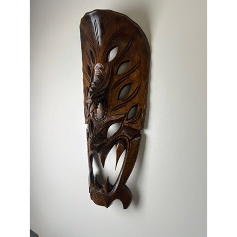 Large wood carved dragon mask with fierce fangs and openwork eyes