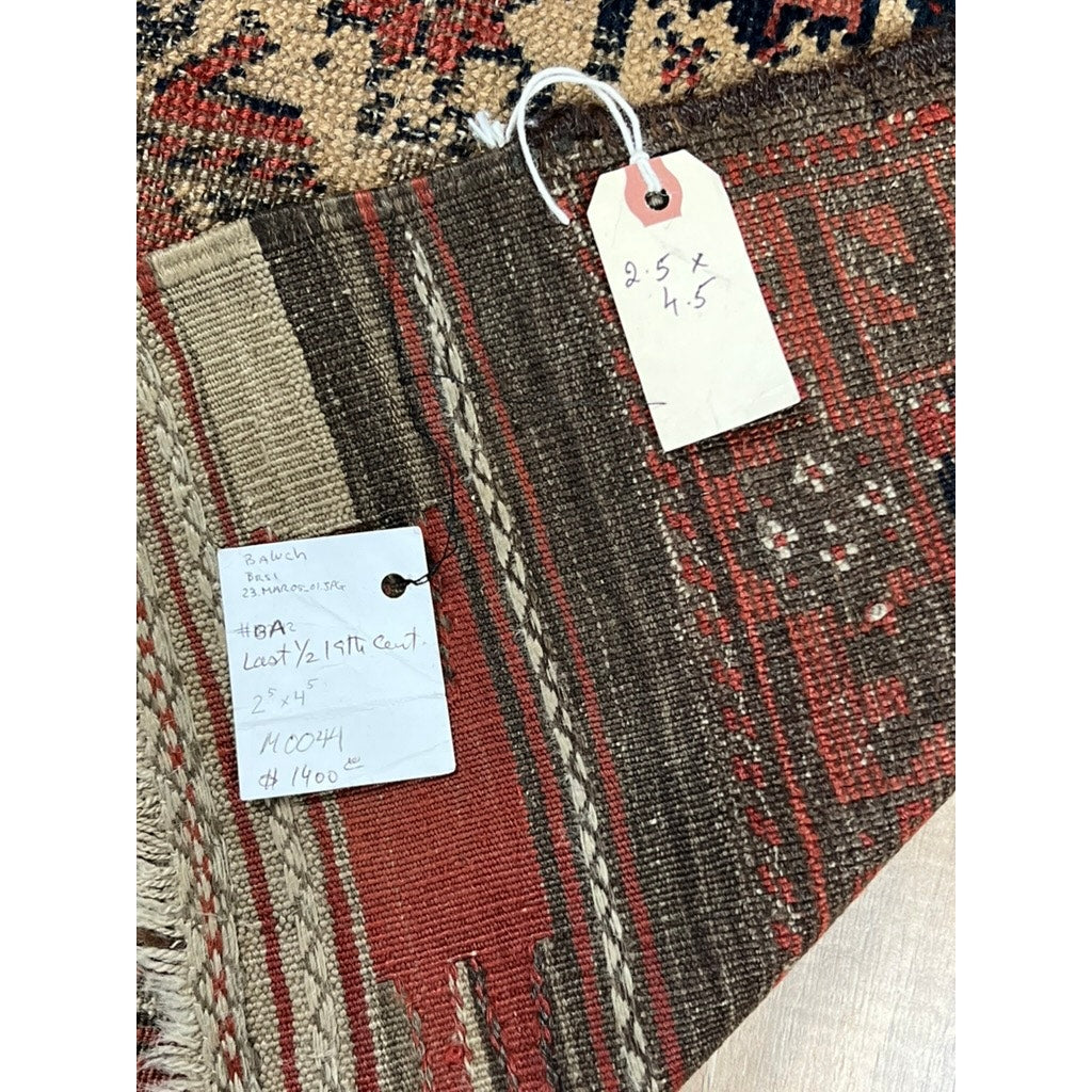 A close-up of an Antique Baluch Prayer Rug with Tree of Life motif, Northeast Persia, mid-19th century (2’5 x 4’5), shows two handwritten tags noting the size and details: #8A, 2.5 x 4, $1400, plus additional notes on this unique piece.