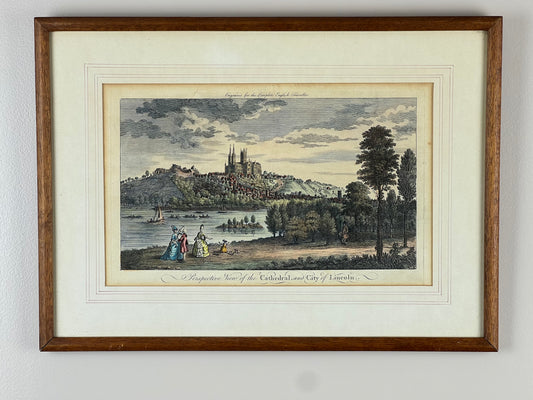 The “Perspective View of the Cathedral and City of Lincoln” Framed Print by Pearl City Antiques captures a riverside cityscape with Lincoln Cathedral, boats, and figures in period dress—ideal for fans of English historical art.