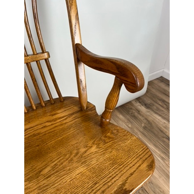Side view of vintage oak Windsor bench with wide seat