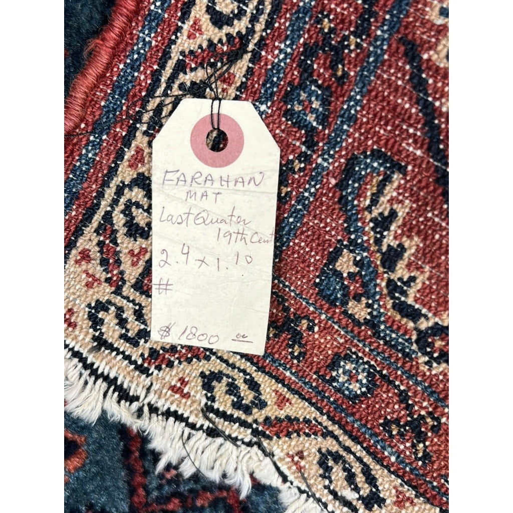 A close-up of an Antique Farahan Mat c. Late 19th Century (1’10 x 2’4), priced at $1800, shows intricate red, blue, and beige patterns with a Herati-style border and fringed edges, plus a handwritten provenance tag.