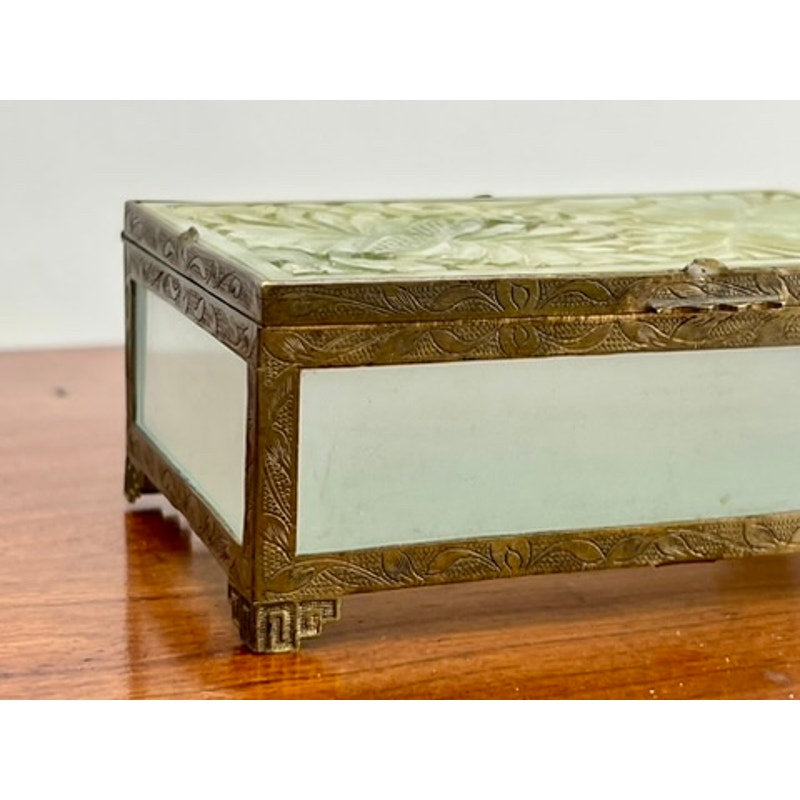 The Antique Chinese Brass Bound Jade and Frosted Glass Dresser Box features frosted glass panels, ornate brass trim, and an embossed floral lid design, creating a timeless decorative piece for any wooden surface.