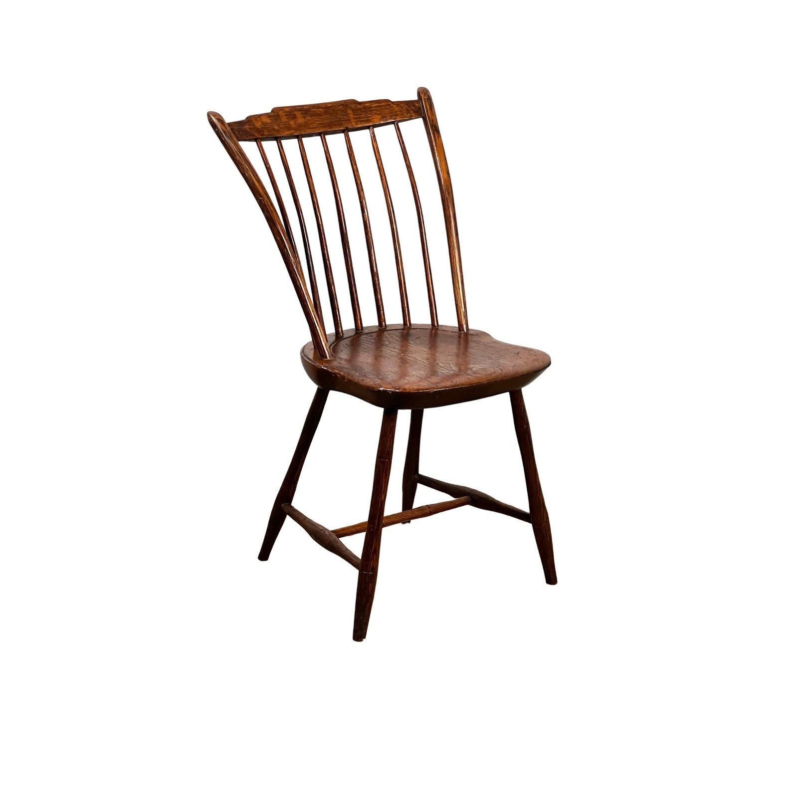 Antique Step Down Windsor Chair in Oak and Pine, early 19th century, featuring a curved backrest with seven vertical spindles, angled legs, and a contoured seat, displayed on a white background. Brand unknown.