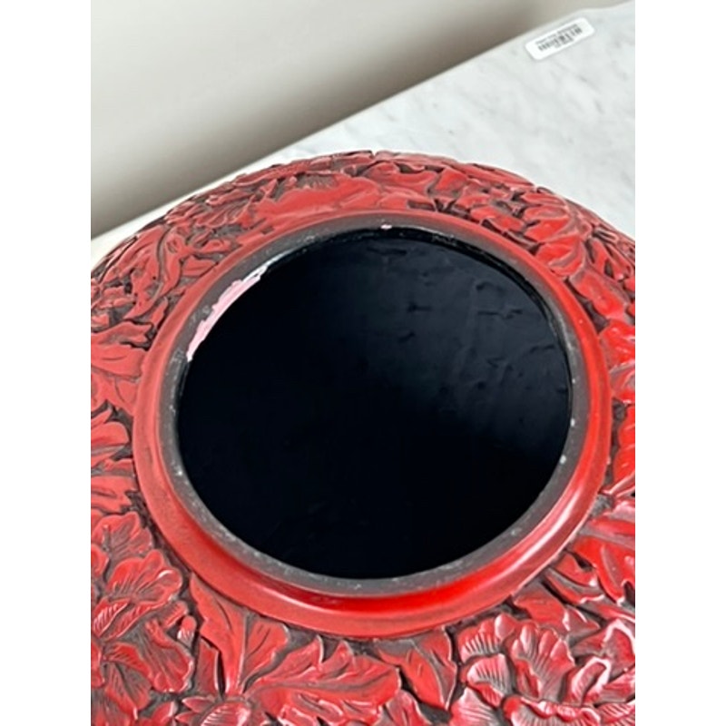 Close-up of the top opening of an Antique Chinese Hand-Carved Cinnabar Lacquered Lidded Jar, probably Qianlong, showing intricate floral patterns and a black interior on a light marble surface. Brand: None/Unknown.
