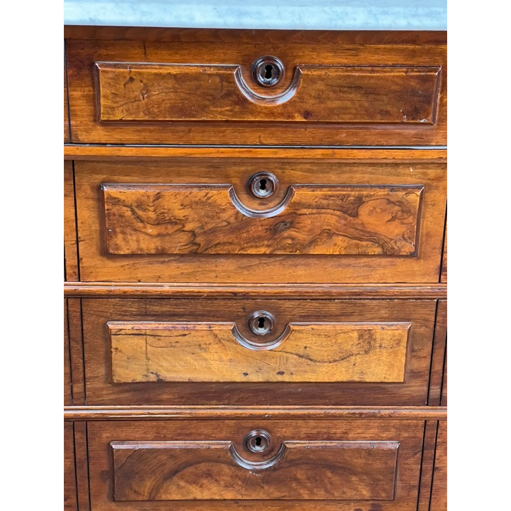 Close-up of four wooden dresser drawers with decorative keyholes and varied wood grain, showing wear and unique textures—details that highlight the charm of an Antique Victorian Marble Top Four Drawer Chest c. 1910. Brand: Unknown.