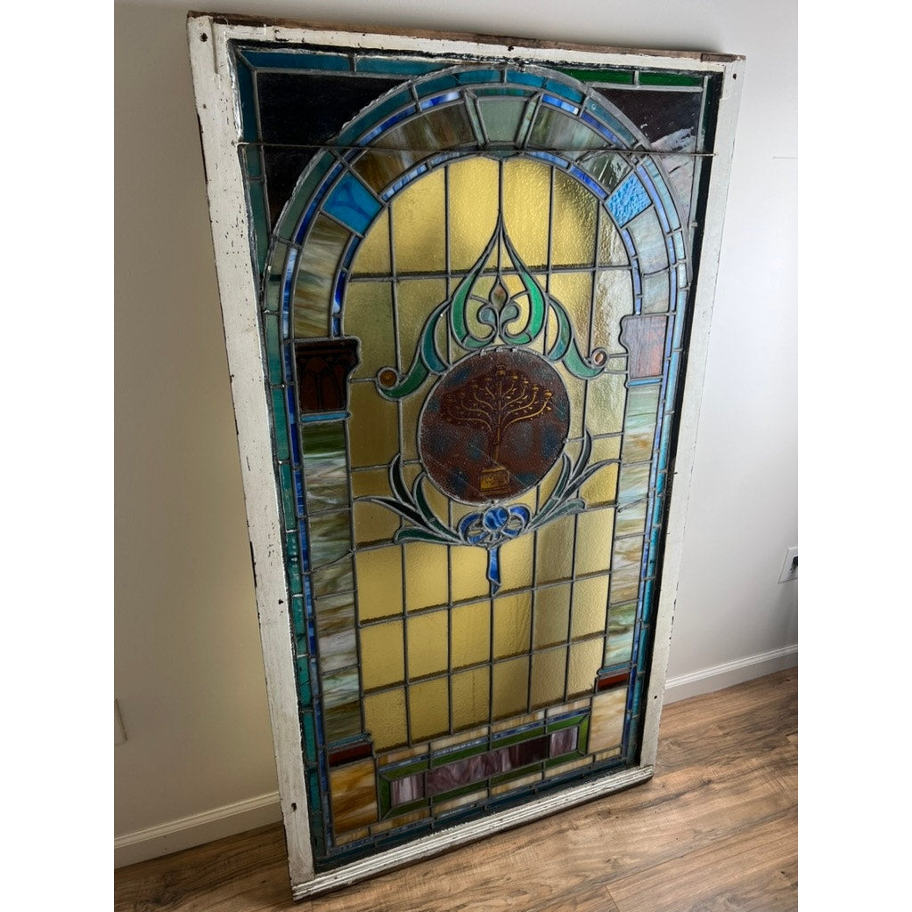 Early 20th century stained glass window in original wood frame
