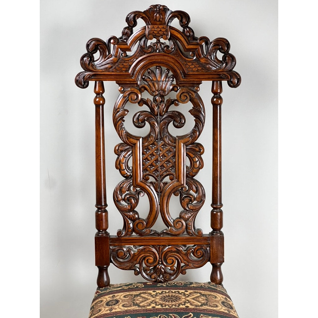 Antique Carolean Revival Side Chair (late 19th c.) with intricate carved scrollwork, floral patterns, vertical side columns, and a tapestry-upholstered seat. Brand: Unknown.