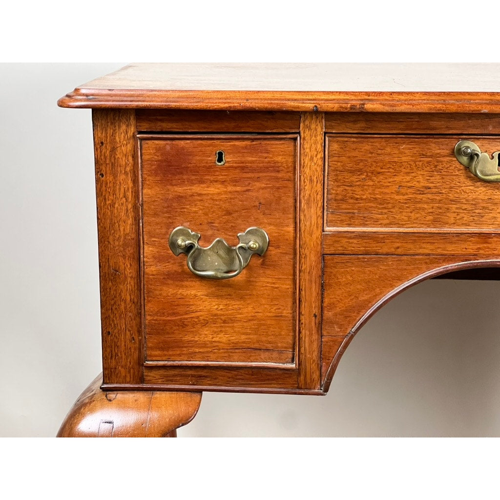 Close-up of an Antique George III Queen Anne Mahogany Lowboy c. Late 18th Century, featuring a brass handle and keyhole. The polished reddish-brown wood and curved legs evoke classic Georgian elegance. Brand: Unknown.