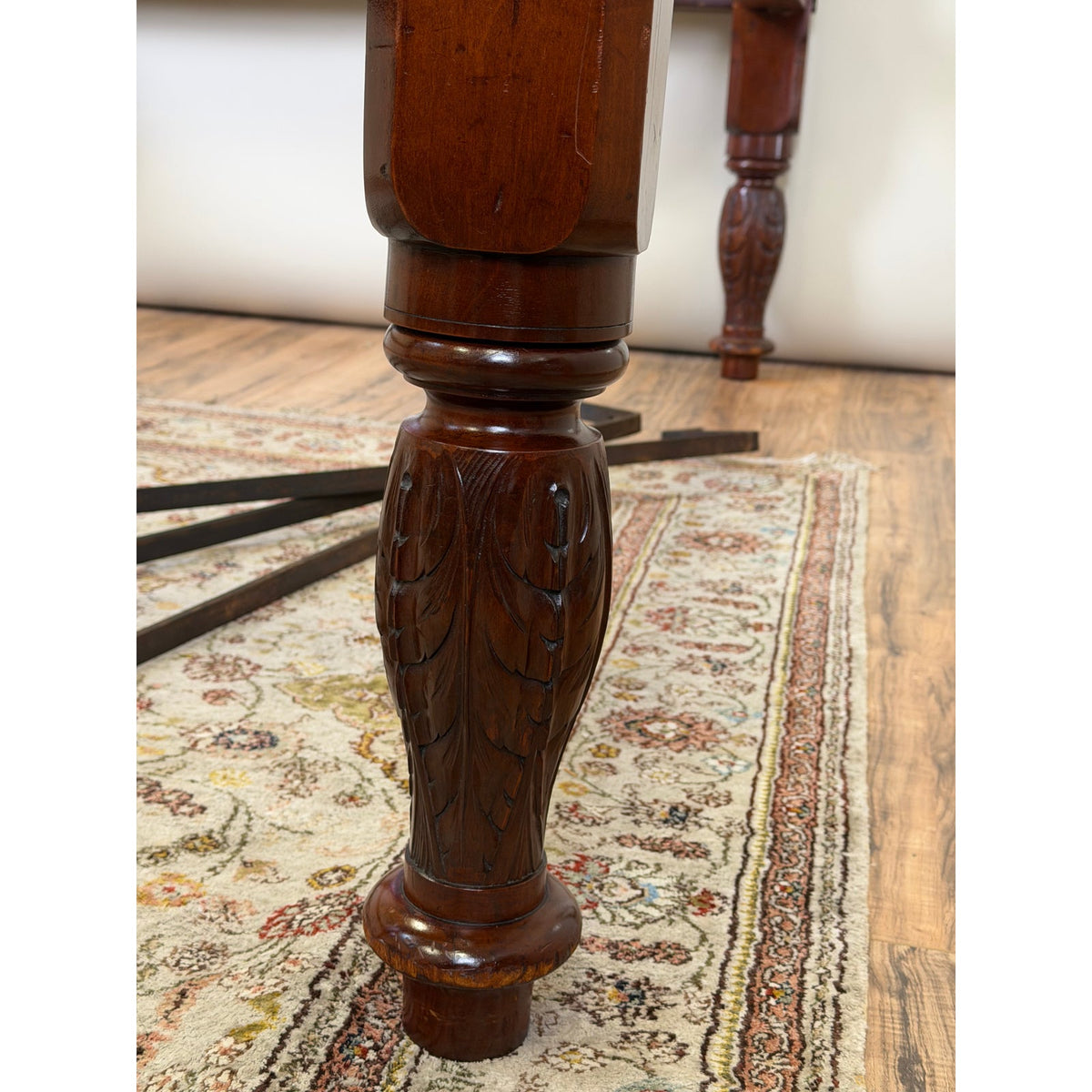 Detail of a 19th-century mahogany bed post from an American Classical Carved Mahogany Four-Poster Tester Bed, Possibly New York, circa 1825–1840, featuring carved acanthus leaf motifs on the leg.