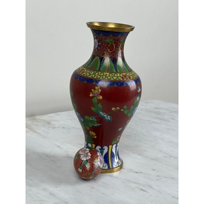 The Vintage Chinese Cloisonné Vase and Egg features colorful floral and leaf designs, displayed on a white marble surface to highlight their exquisite enamel artistry. Brand: None/Unknown.