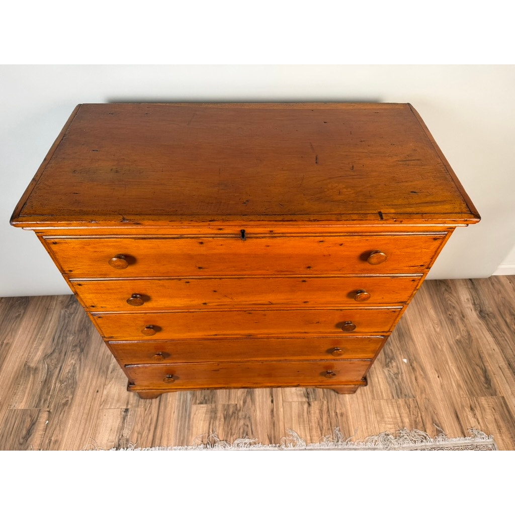 A late 18th-century New England pine two-drawer blanket chest by Pearl City Antiques, shown from above. Characteristic of early American country furniture, the warm brown wood sits on a wood floor with a small section of rug visible at the bottom.