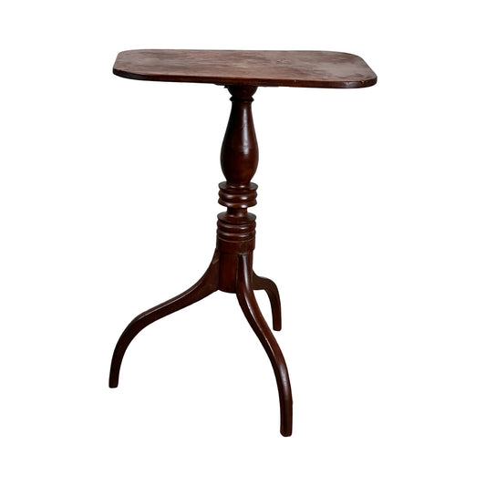 This Antique Federal Period Cherry Hepplewhite Candle Stand (mid 19th century) features a small, dark wooden square top, single turned pedestal, and three curved legs with a classic design. Brand: None/Unknown.
