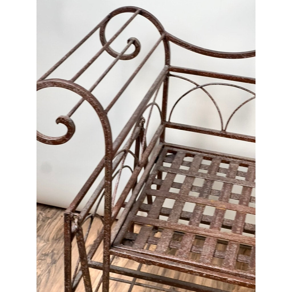 Vintage Regency Style Wrought Iron Porch Glider featuring a brown lattice seat and decorative scrollwork, evokes classic garden charm; showcased on a wooden floor with a plain white background. Brand: None/Unknown.