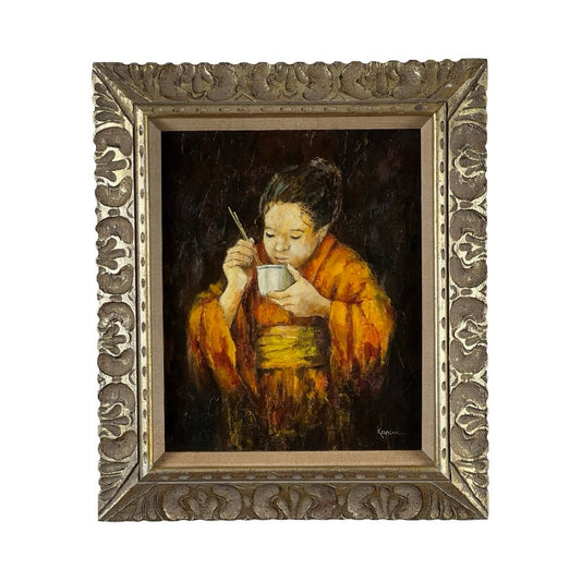 Vintage Mid Century oil on canvas painting, “Girl in Kimono” signed Korim, depicts a girl in an orange and yellow kimono eating with chopsticks. Set against a dark background, it comes in an ornate gold frame with intricate floral patterns. Brand unknown.