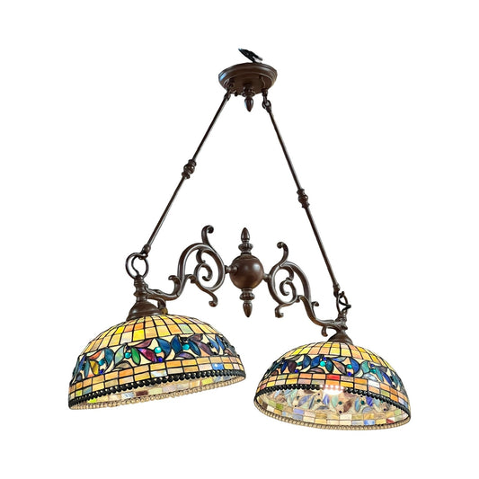 The Vintage Tiffany Style Leaded Stained Glass Double Pendant Billiard Island Light features two stained glass lampshades adorned with colorful butterfly and floral patterns, suspended from ornate metal arms—making it an eye-catching addition above a kitchen island.