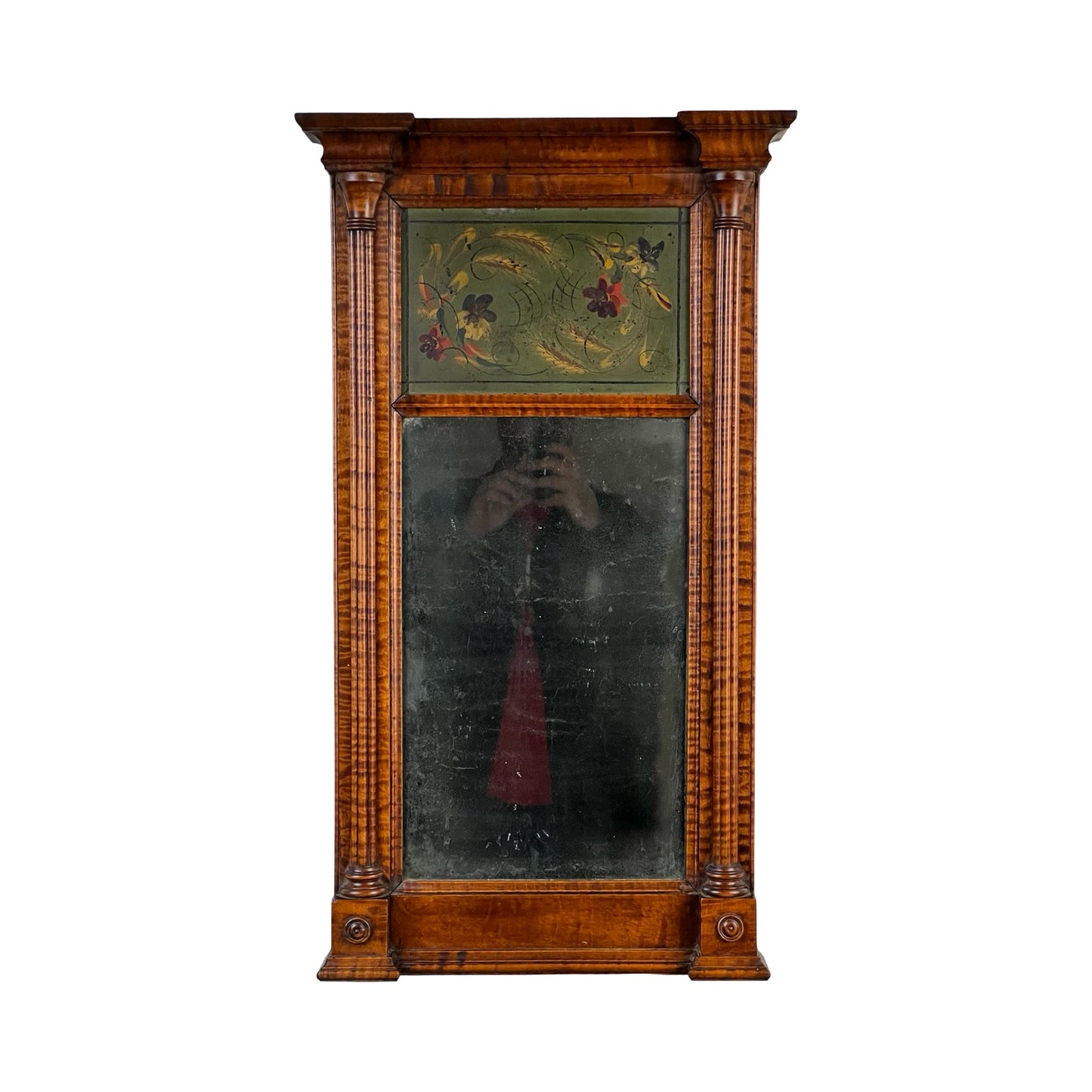 Fine Antique Federal Period Tiger Maple Two Panel Mirror c. 1820 with carved frame, columns, rectangular glass, and decorative painted floral panel. Early 19th-century American craftsmanship; a person’s reflection can be seen.