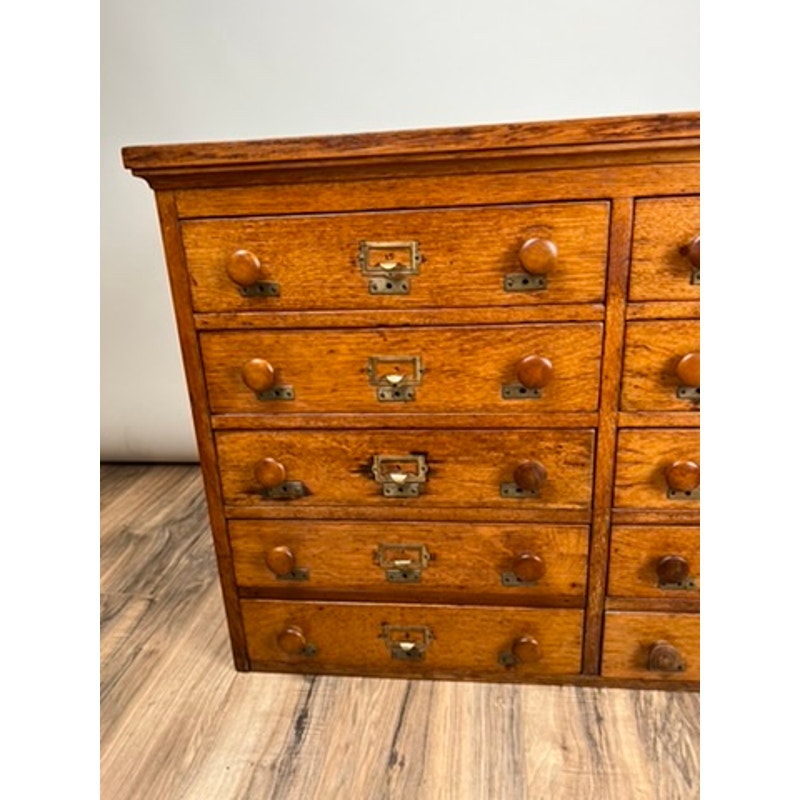 Early 20th century oak file cabinet with multiple drawers, antique office furniture.