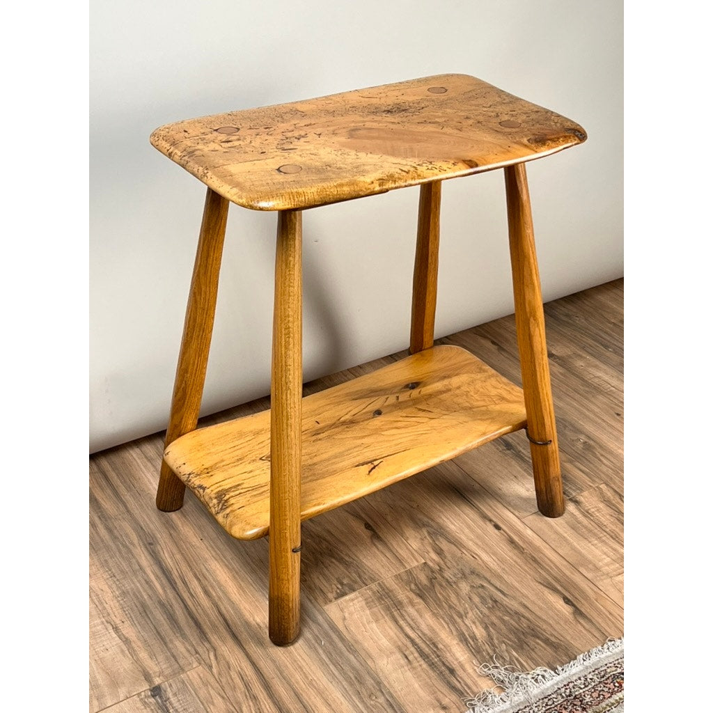 A Vintage Wabi Sabi Bench from spalted maple, signed by Neil Panyik, is displayed on a wood floor against a plain light-colored wall.