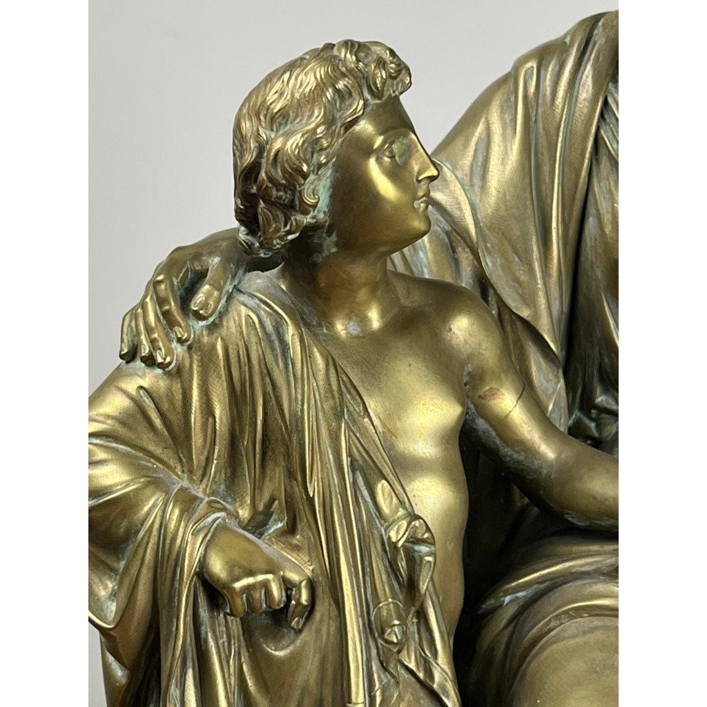 Antique Bronze Sculpture “Teacher and Pupil” by Louis Charles Janson, signed Ch. Janson (1865), depicts a young figure with curly hair and draped cloth beside another with an arm resting on their shoulders in timeless classical style.