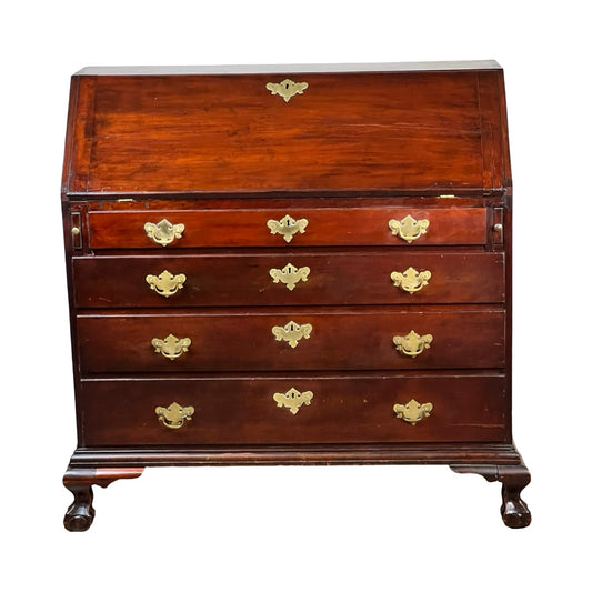An 18th Century New England Chippendale cherry slant front desk, circa 1770–1790, featuring four drawers with brass handles and cabriole legs. The closed top section has a slanted front designed for writing, exemplifying classic Chippendale style from the period. Brand unknown.