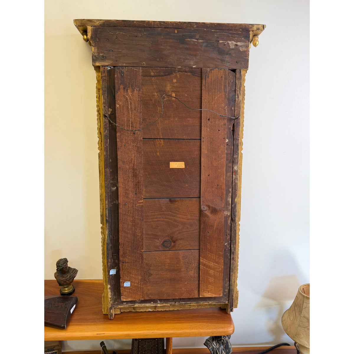 The back of an American Federal Giltwood Pier Mirror, Possibly Massachusetts or New York, circa 1815–1830, showing horizontal wooden planks and a wire hanging cord.