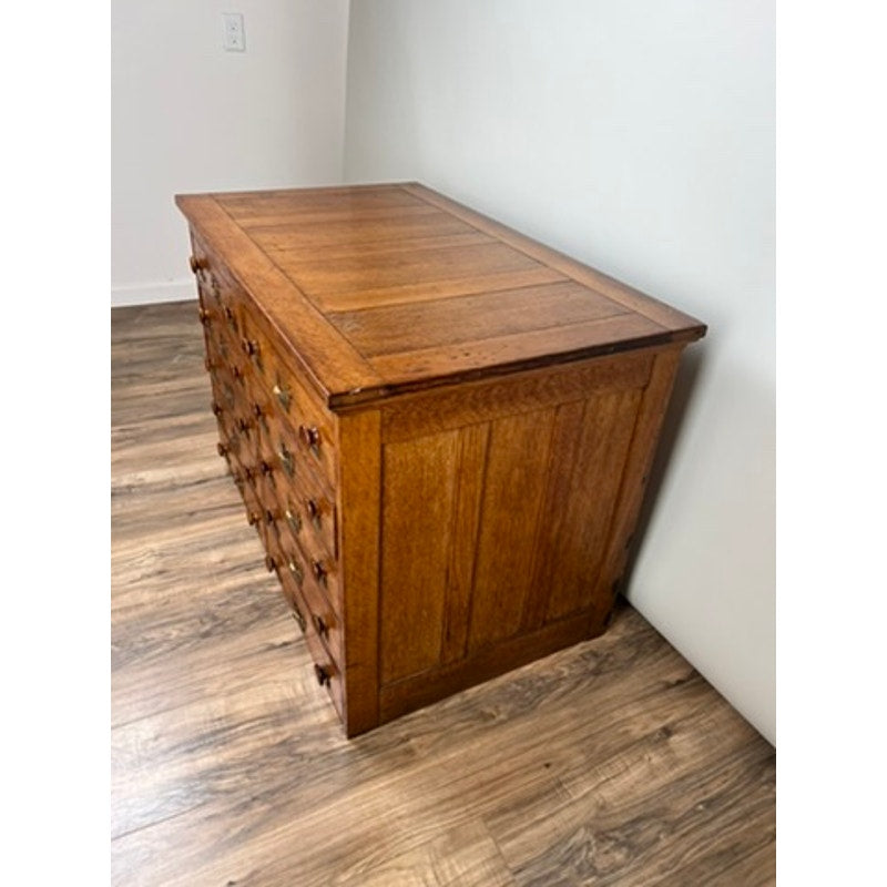 Early 20th century oak file cabinet with multiple drawers, antique office furniture.