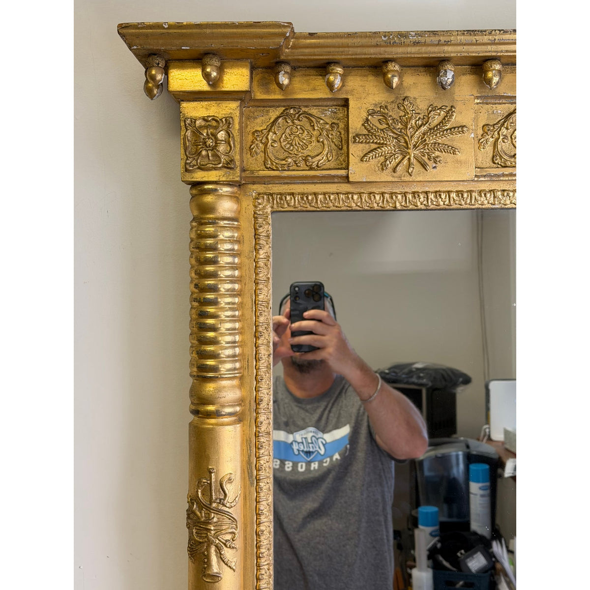 Close-up of an American Federal Giltwood Pier Mirror, possibly Massachusetts or New York, circa 1815–1830, featuring a giltwood frame with ornate carved details, including fluted columns and floral motifs.
