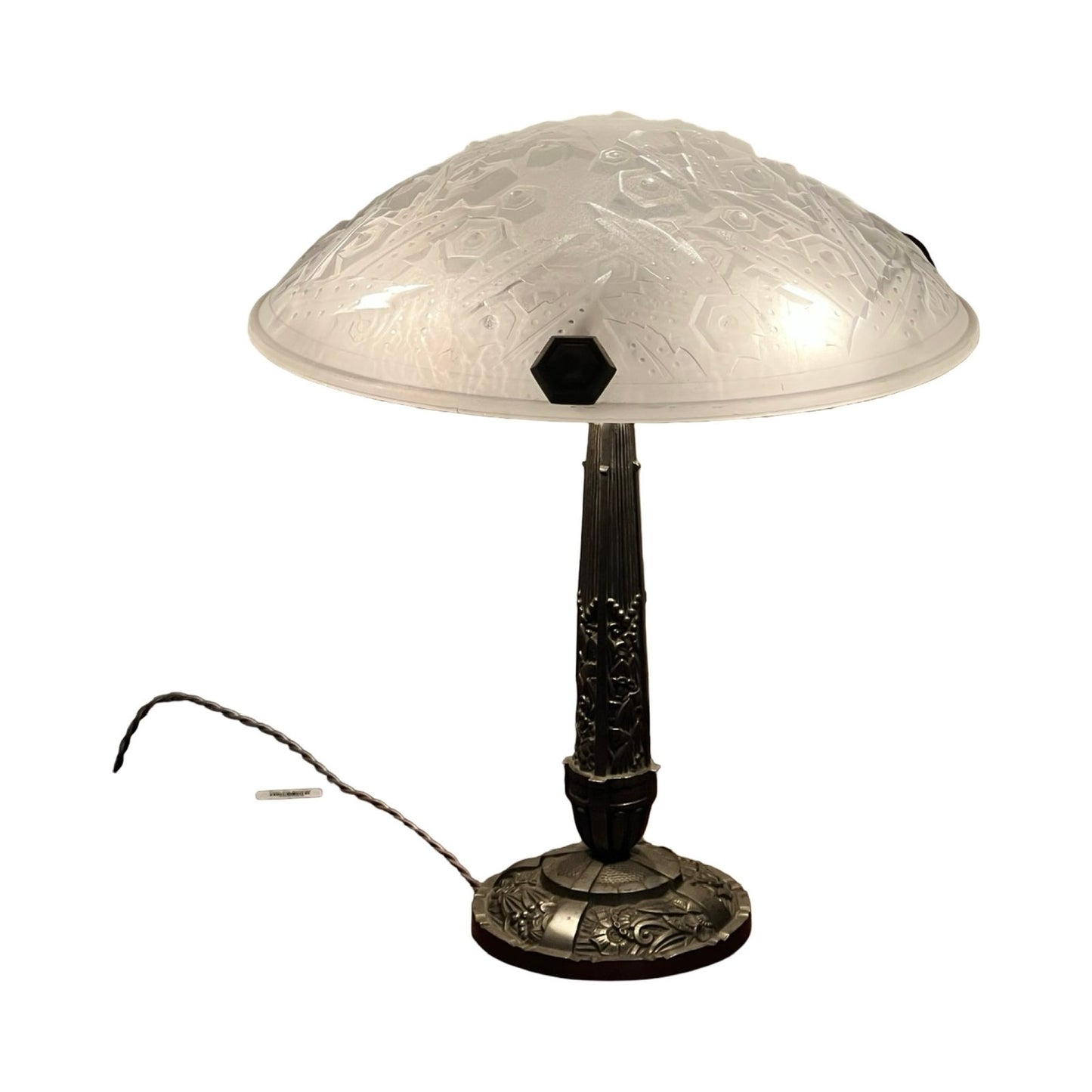 Vintage French Art Deco table lamp by Muller Frères Lunéville c. 1920, featuring a frosted, engraved glass dome shade and ornate dark metal base with decorative patterns. Power cord extends from base. Brand: unknown.