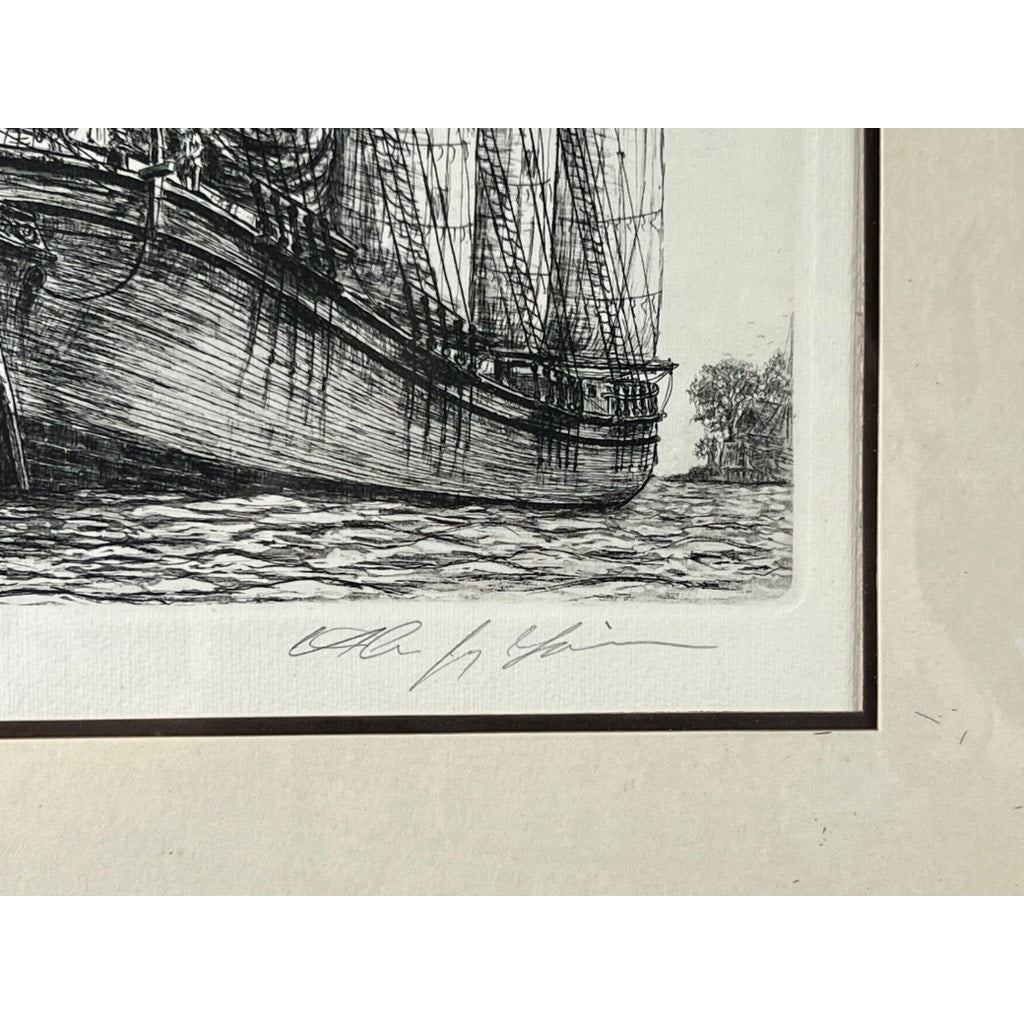 Close-up of “The Schooner,” a framed black and white etching by Alan Jay Gaines, featuring a detailed ship on water. A handwritten signature appears on the mat below—making this maritime piece a striking collectible.