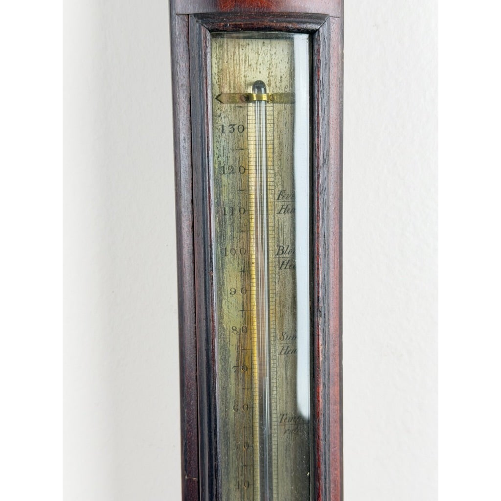 An English Regency Mahogany Stick Barometer by Thomas Jones, Liverpool, c. 1820, featuring a vertical mahogany frame with a glass-enclosed scale labeled with numerical increments.
