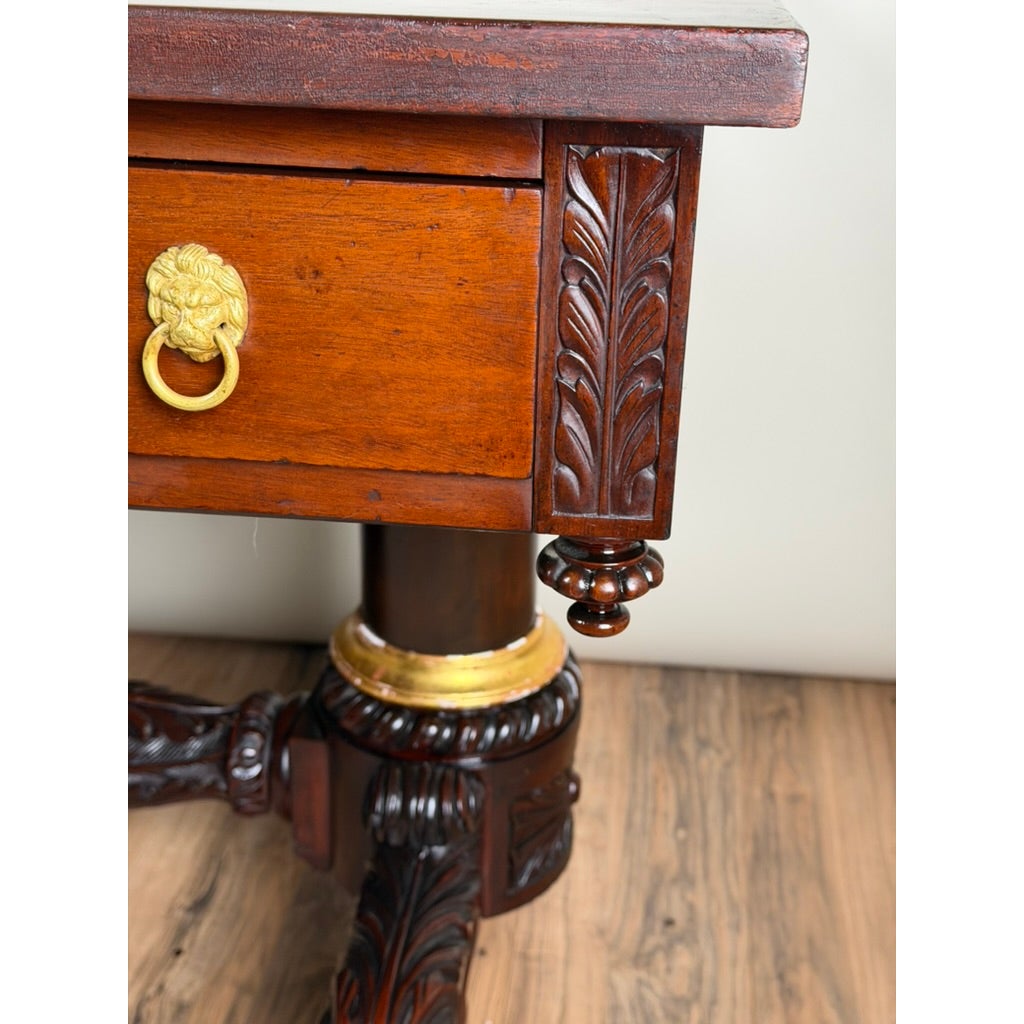New York Classical Revival Carved Mahogany Double-Pedestal Library Table by Pearl City Antiques, featuring a gold lion-head drawer pull and a pedestal base with gilded accents.