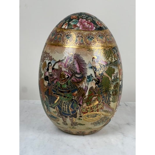 The Large Antique Satsuma Porcelain Egg Chinese Export by Pearl City Antiques is a decorative, egg-shaped vase adorned with vibrant scenes of samurai warriors and horses, intricate floral motifs, and shimmering gold accents on a white backdrop—a remarkable piece of Asian export collectible art.
