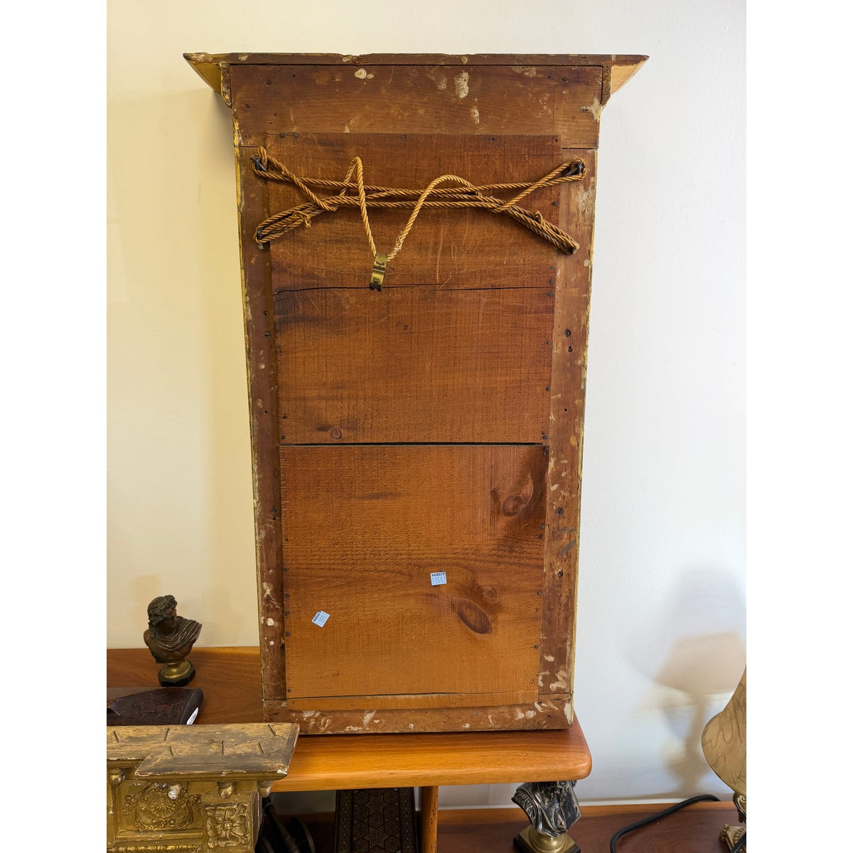 The back of an American Federal Giltwood Two-Plate Looking Glass, Probably Massachusetts, circa 1810–1830, showing the tall, rectangular frame with a thick rope attached for hanging.