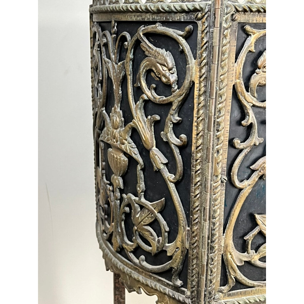 Close-up of an Antique Gothic Revival Cast Iron and Brass Phone Stand, attributed to Oscar Bach or Bertram Segar (c. 1920 Greenwich Village), featuring ornate animal motifs and raised gold designs reminiscent of period decorative furniture.