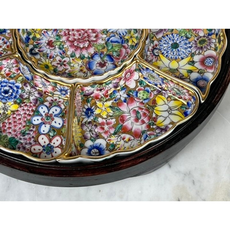 A Vintage Chinese Canton Sweet Meat Set with Case, c. Early 20th Century, rests on a dark wooden tray atop marble. The ceramic dish features multiple sections with colorful floral patterns bordered in gold. Brand unknown.